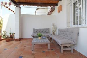 a living room with two couches and a table at Del Parque Flats - Golf & Beach in Rincón de la Victoria
