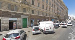 a busy city street with cars parked in front of a building at Art And Relax Suites in Rome
