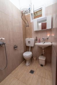 a bathroom with a toilet and a sink and a shower at Litochoro Rooms in Plaka Litochorou