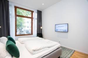 Säng eller sängar i ett rum på ApartDirect Sundbyberg