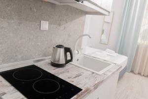 a tea kettle on a counter in a kitchen at Polyxeni's Studios in Limenas +21 photos