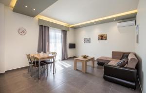 a living room with a couch and a table at Studios & Apartments Elisabeta in Limenaria