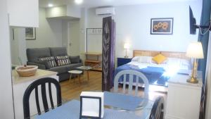a room with a bed and a living room at Casa Armas A, en Zocodover, Casco Histórico in Toledo
