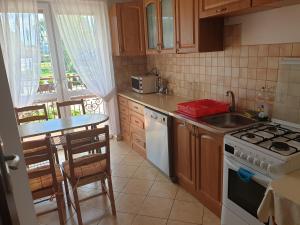 a kitchen with a sink and a stove top oven at POKOJE U MIKOŁAJA in Kamień Pomorski