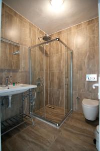 a bathroom with a shower and a sink and a toilet at Agva Nehir Evi - Adult Only in Ağva