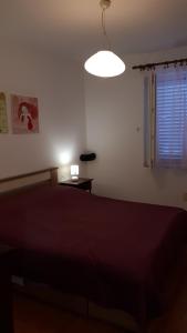 a bedroom with a large bed and a lamp at Best4You Apartment - sea view - 70 m2 - 2 bedrooms in Dubrovnik
