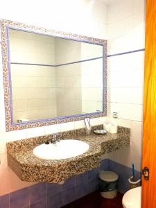 a bathroom with a sink and a mirror at Hostal Restaurante Ego's in Campo de Criptana +221 photos