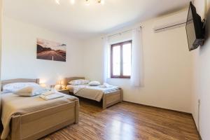 Posteľ alebo postele v izbe v ubytovaní Kelava Rooms