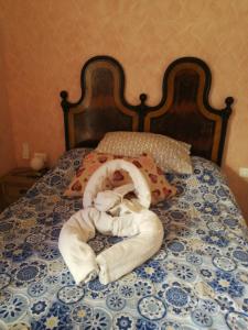 a stuffed animal is laying on a bed at Agriturismo Nonni Devia in Lucinasco