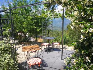 a table and chairs on a patio with a view at Agriturismo Nonni Devia in Lucinasco