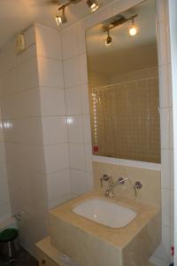 a bathroom with a sink and a mirror at Chilean Suites and Apartment in Santiago