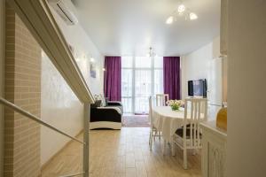 a living room with a table and a dining room at Apartament First Line in Karolino-Buhaz