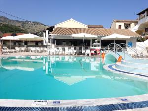 a large pool with blue water in a resort at Kalimera Apartments in Kassiopi