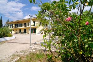 a building with a lot of flowers in front of it at anastasios paleokastritsa studios in Doukádes +3 photos