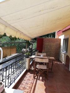 a patio with a table and chairs under an umbrella at Forest 22 in Kavala