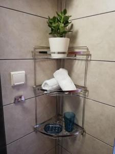 a towel rack with a potted plant on it in a bathroom at Forest 22 in Kavala