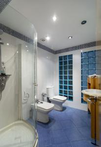 a bathroom with two toilets and a shower and a sink at Villa Casakhan, Beautiful Luxury Villa, in Marbella