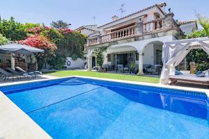 a villa with a swimming pool and a house at Villa Casakhan, Beautiful Luxury Villa, in Marbella
