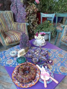 a purple table with plates of food on it at Mai̇ Hotel in Çeşme