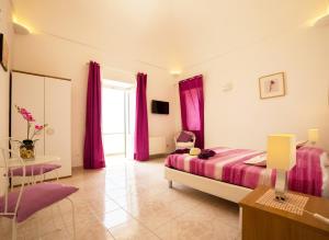 a large bedroom with purple curtains and a bed at Villa Marilisa in Conca dei Marini