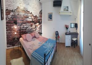a bedroom with a bed and a brick wall at Holiday Home Dioniza in Vodnjan +31 photos