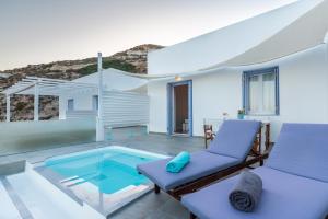 a villa with a swimming pool and a patio at Milesian Suites in Adamas