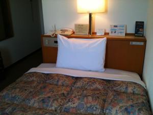 Voodi või voodid majutusasutuse Ace Inn Matsusaka toas