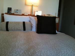 Voodi või voodid majutusasutuse Ace Inn Matsusaka toas