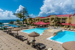 a resort with a pool and chairs and umbrellas at Simpson Bay Resort Marina & Spa in Simpson Bay