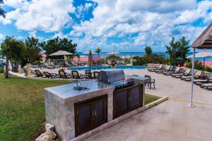 a outdoor bar with a tv on it next to a pool at Simpson Bay Resort Marina & Spa in Simpson Bay