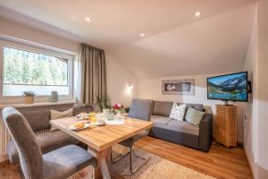 a living room with a couch and a table at Haus Schlechter in Mayrhofen