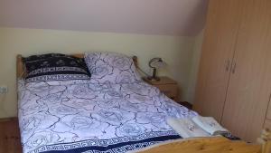 a bed with purple and white sheets and pillows at Marco in Świętoszówka