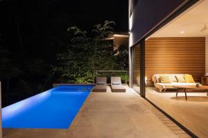 a swimming pool in the backyard of a house at Panavision Villas in Santa Teresa Beach
