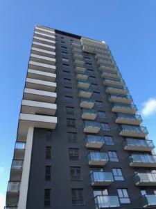 a tall black apartment building with balconies at Jacuzzi Suite in Gdańsk