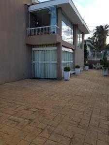 a building with a patio in front of it at Cantinho DelMar in Olímpia