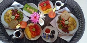 a plate of food on a table with plates of food at Bali Harmony Villa in Ubud