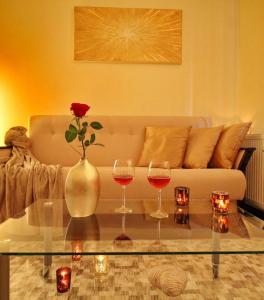 a living room with a couch and two glasses of wine at Castle Court Apartment in Budapest