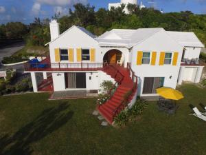 a white house with a slide in the yard at AMOuR AMOUR in Southampton