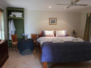 A bed or beds in a room at Noosa Edge Nudist Retreat