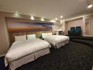 Postel nebo postele na pokoji v ubytování Ximen Airline Hotel