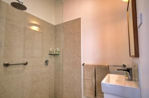 a bathroom with a shower and a sink at Cloudscape Apartment No 2 in Kingscote