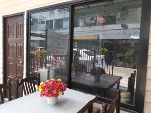 a table with a vase of flowers on top of it at OK.home@Donmuang airport in Bangkok
