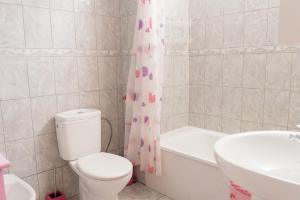 a bathroom with a toilet and a tub and a sink at Las Piteras (1) in Arona +5 photos