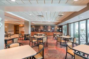 a restaurant with tables and chairs and a bar at Wingate by Wyndham (Lexington, VA) in Lexington
