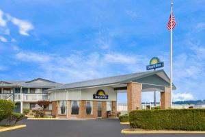 a hotel with an american flag in front of it at Days Inn by Wyndham Auburn in Auburn