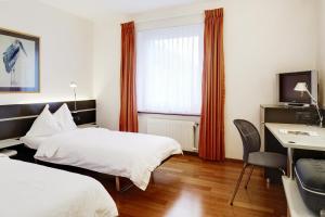 Postelja oz. postelje v sobi nastanitve Hotel du Commerce