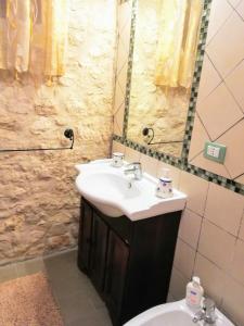 a bathroom with a sink and a toilet and a mirror at Torre Rodosta in Modica +40 photos