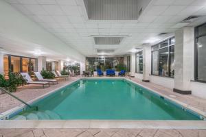 a pool in a hotel lobby with chairs and tables at Wingate by Wyndham (Lexington, VA) in Lexington