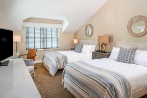 a hotel room with two beds and a television at Edgar Hotel Martha's Vineyard, Ascend Hotel Collection in Edgartown