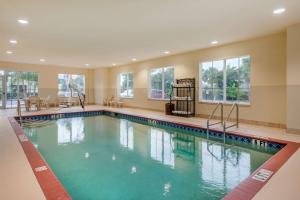 a large swimming pool in a hotel room at Comfort Inn & Suites Fort Myers Airport in Fort Myers